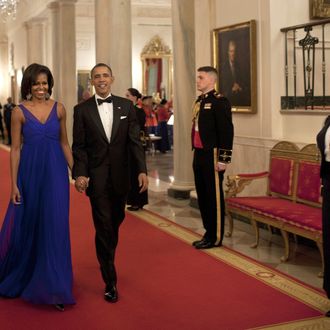 US President Barack Obama and first lady Michelle Obama walk through the Cross Hall to the East Room of the White House on February 29, 2012 in Washington. Obama and his wife Michelle hosted a dinner for members of the US armed forces who served in Iraq and Afghanistan. AFP PHOTO/Brendan SMIALOWSKI (Photo credit should read BRENDAN SMIALOWSKI/AFP/Getty Images)