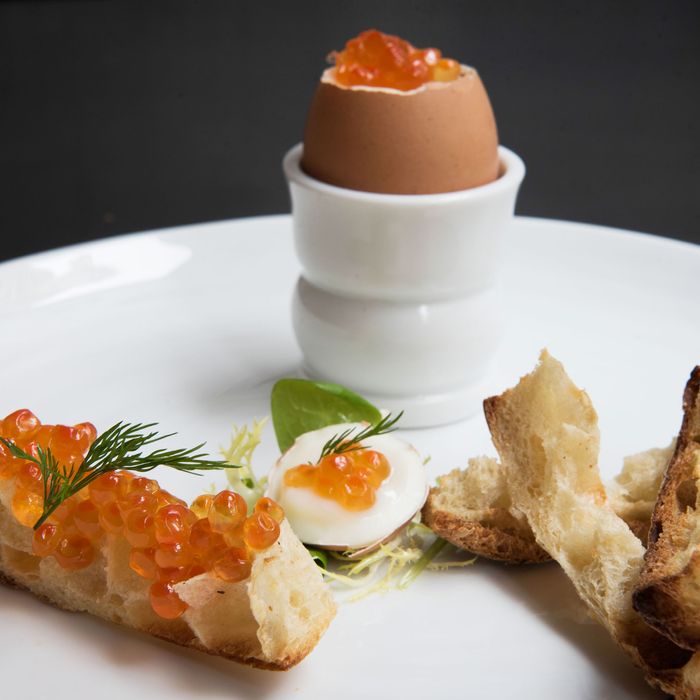 Soft-boiled eggs topped with salmon roe and dill, and served with butter soldiers for dipping.