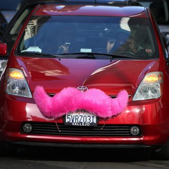 A Lyft car sits at a stoplight on January 21, 2014 in San Francisco, California.