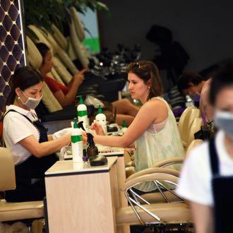 11 May 2015, New York City, New York State, USA --- epa04743737 A woman gets a manicure at a nail salon in New York, New York, USA, 11 May 2015. After a New York Times newspaper report about health hazards of chemicals used in some salons and wage issues within in the industry, New York Governor Andrew Cuomo on 10 May announced a multiagency task force that will conduct salon-by-salon investigations. EPA/JUSTIN LANE --- Image by ? JUSTIN LANE/epa/Corbis