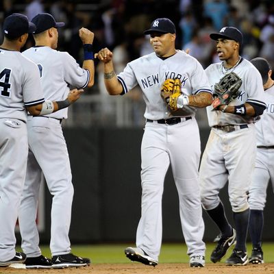 Robinson Cano #24, Derek Jeter #2, Andruw Jones #18, Curtis Granderson #14 and Brett Gardner #11 of the New York Yankees celebrate a win against the Minnesota Twins on August 18, 2011.