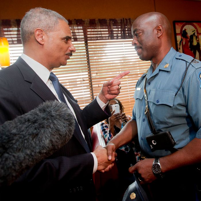 FLORRISSANT, MO - AUGUST 20: U.S. Attorney General Eric Holder (L) talks with Capt. Ron Johnson, right, of the Missouri State Highway Patrol at Drake's Place Restaurant,August 20, 2014 in Florrissant, Missouri. Holder is traveling to Ferguson, Mo., to oversea the federal government's investigation into the shooting of 18-year-old Michael Brown by a police officer on Aug. 9th. Holder promised a 