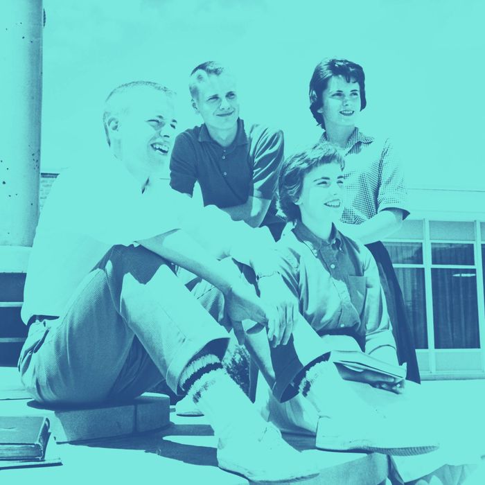 Two teenage boys and two teenage girls sitting together