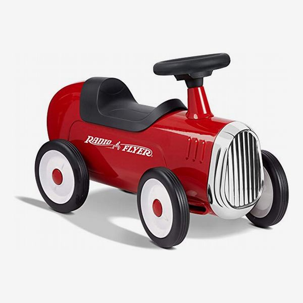 A bright red Radio Flyer Little Red Roadster riding toy with a black seat and steering wheel, white, black, and red wheels a Radio Flyer logo in white on the side, and a chrome grill. The Strategist - 48 Things on Sale You’ll Actually Want to Buy: From Sunday Riley to Patagonia