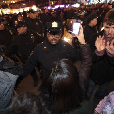 03 Dec 2014, New York City, New York State, USA --- New York, United States. 3rd December 2014 -- NYPD officers confront protestors in standoff near Rockefeller Center after thousands took to the streets to protest a Staten Island grand jury's failure to indict NYPD officer Daniel Pantaleo in the chokehold death of Eric Garner. -- Thousands of activists gathered throughout New York City after it was announced that the Richmond County grand jury investigating the death of Eric Garner failed to indict NYPD officer Daniel Pantaleo for use of an illegal chokehold. Arrests ensued. --- Image by ? Andy Katz/Demotix/Corbis