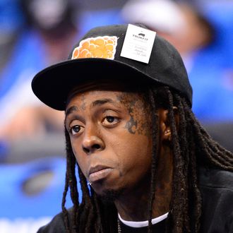 OKLAHOMA CITY, OK - JUNE 12: Rapper Lil Wayne sits courtside during halftime as the Oklahoma City Thunder take on the Miami Heat in Game One of the 2012 NBA Finals at Chesapeake Energy Arena on June 12, 2012 in Oklahoma City, Oklahoma. NOTE TO USER: User expressly acknowledges and agrees that, by downloading and or using this photograph, User is consenting to the terms and conditions of the Getty Images License Agreement. (Photo by Ronald Martinez/Getty Images)