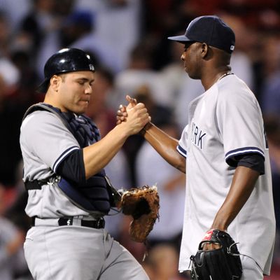 Catcher Russell Martin #55 and pitcher Rafael Soriano #29 of the New York Yankees celebrate a 2-0 win over the Boston Red Sox on September 13, 2012 at Fenway Park in Boston, Massachusetts.