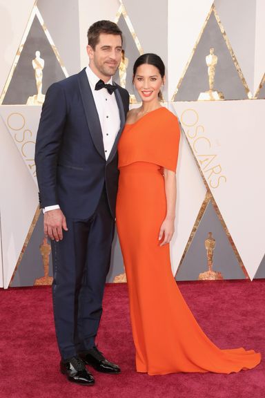 Aaron Rodgers and Olivia Munn 
Tuxedo by Isaia; shoes by Salvatore Ferragamo tuxedo studs and cuff links by Neil Lane; dress by Stella McCartney; jewels by Forevermark Diamonds.