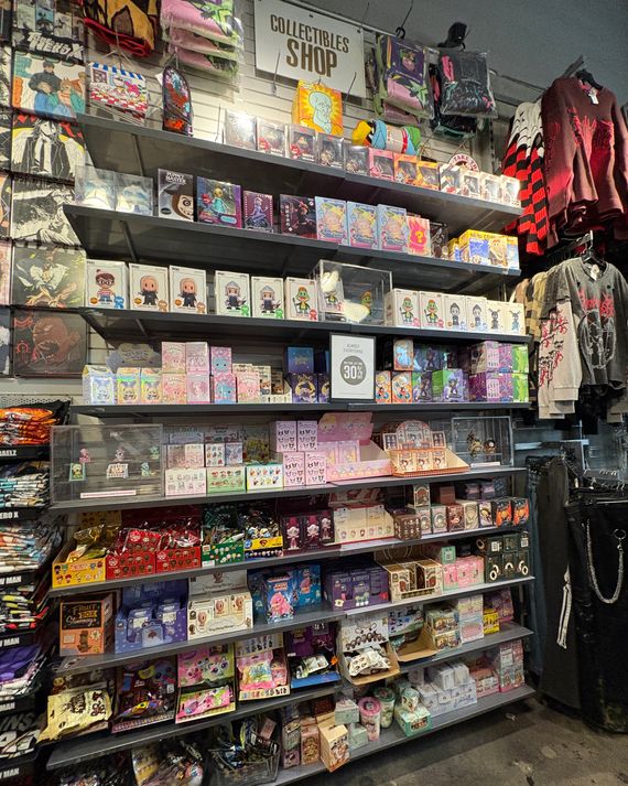 A floor-to-ceiling display of various blind boxes. 
