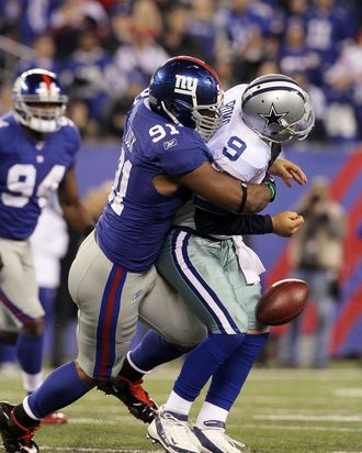 Justin Tuck #91 of the New York Giants sacks Tony Romo #9 of the Dallas Cowboys on January 1, 2012 at MetLife Stadium in East Rutherford, New Jersey. The Giants defeated the Cowboys 31-14. 