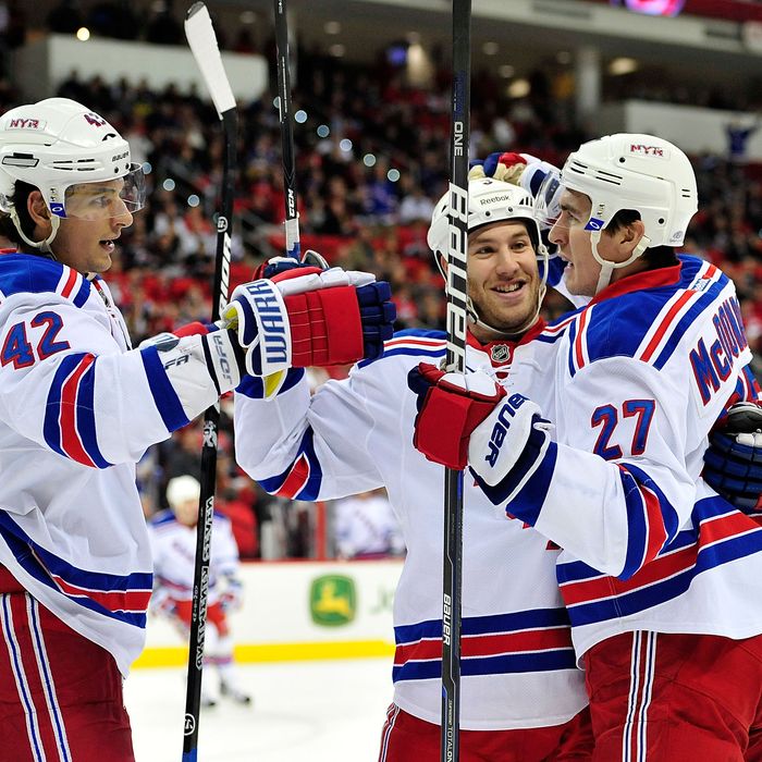 RALEIGH, NC - DECEMBER 01: Artem Anisimov #42, Brandon Prust #8 and Ryan McDonagh #27 of the New York Rangers celebrate McDonagh's goal against the Carolina Hurricanes during play at the RBC Center on December 1, 2011 in Raleigh, North Carolina. (Photo by Grant Halverson/Getty Images)