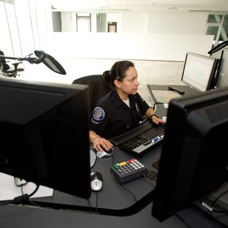  911 dispatcher Leticia Hernandez works at her station at the new Police building. 