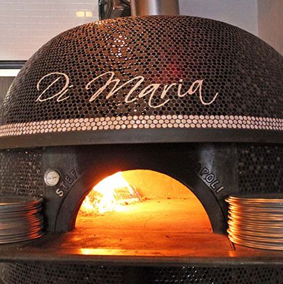 The Sefano Ferrara wood-fired oven was built in Naples, and heats to over 1,000 degrees, cooking pieces in under 2 minutes.