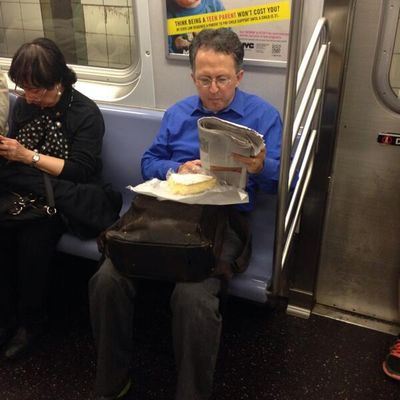 Otherwise Respectable Man Devours Massive Piece of Brie on Subway