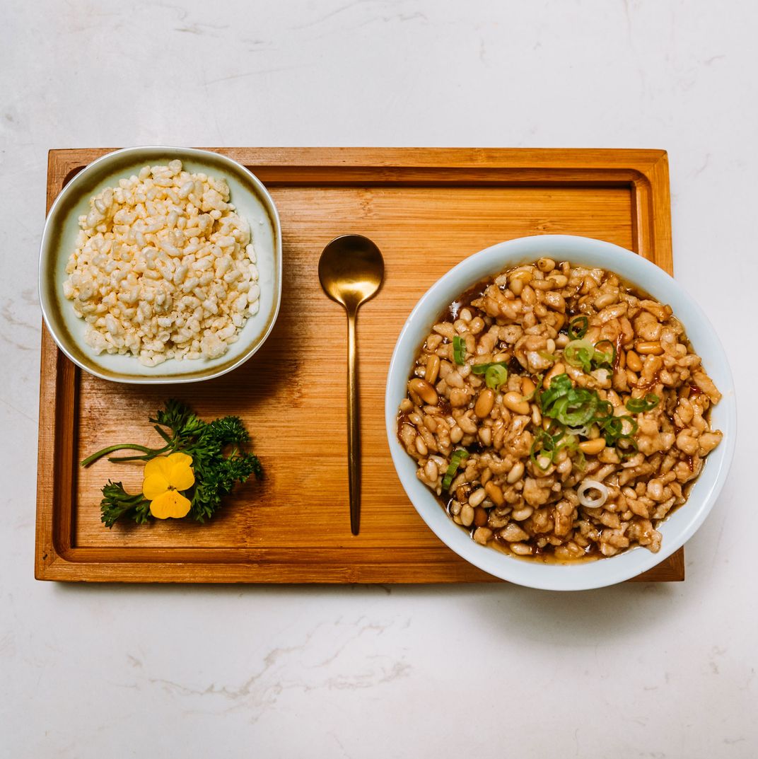 Chicken lettuce wrap with pine nuts and rice crispies.