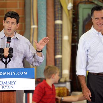 HIGH POINT, NC - AUGUST 12: Republican presidential candidate, former Massachusetts Gov. Mitt Romney (R), is introduced by running mate Republican vice presidential candidate, U.S. Rep. Paul Ryan (R-WI) during a campaign stop at the Absolute Style furniture factory on August 12, 2012 in High Point, North Carolina. Romney and Ryan continue on the second day of a 4-day bus trip that will take Romney to 4 key swing states, Virginia, North Carolina, Florida and Ohio, and also to Ryan's home state of Wisconsin. (Photo by Sara D. Davis/Getty Images)