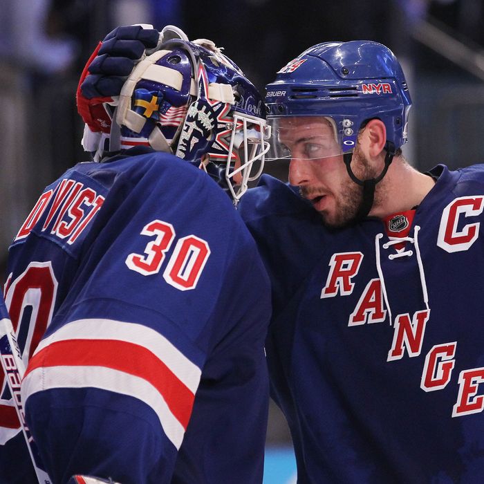Henrik Lundqvist #30 and Ryan Callahan #24 of the New York Rangers celebrate their 3 to 0 win over the New Jersey Devils in Game One of the Eastern Conference Finals during the 2012 NHL Stanley Cup Playoffs at Madison Square Garden on May 14, 2012 in New York City.