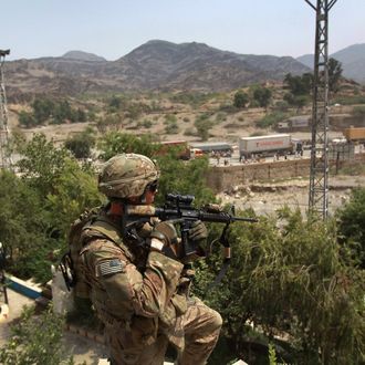 TORKHAM, AFGHANISTAN - AUGUST 27: U.S. Army Sgt. David Ward watches over the border crossing between Afghanistan and Pakistan August 27, 2011 at Torkham, Afghanistan. The port of entry is busiest in Afghanistan and the most important for the U.S. military, which imports more than 30 percent of all its supplies and military equipment through Torkham. (Photo by John Moore/Getty Images)