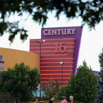 AURORA, CO - JULY 23: People stand in the parking lot outside the Century 16 movie theater where 12 people were killed in a shooting rampage last Friday, on July 23, 2012 in Aurora, Colorado. Suspect James Holmes, 24, allegedly went on a shooting spree and killed 12 people and injured 58 during an early morning screening of 'The Dark Knight Rises.' (Photo by Kevork Djansezian/Getty Images)