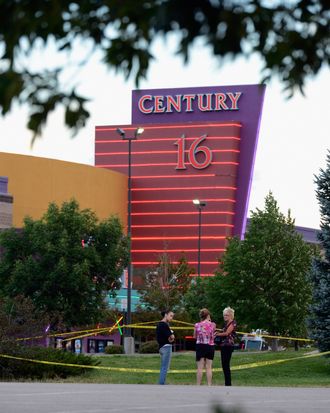 AURORA, CO - JULY 23: People stand in the parking lot outside the Century 16 movie theater where 12 people were killed in a shooting rampage last Friday, on July 23, 2012 in Aurora, Colorado. Suspect James Holmes, 24, allegedly went on a shooting spree and killed 12 people and injured 58 during an early morning screening of 'The Dark Knight Rises.' (Photo by Kevork Djansezian/Getty Images)