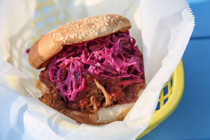 Pulled pork with ginger barbecue sauce and sesame slaw on a semolina roll.