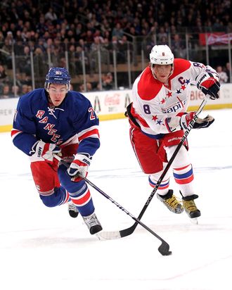 Ryan McDonagh #27 of the New York Rangers skates with the puck in front of Alex Ovechkin #8 of the Washington Capital