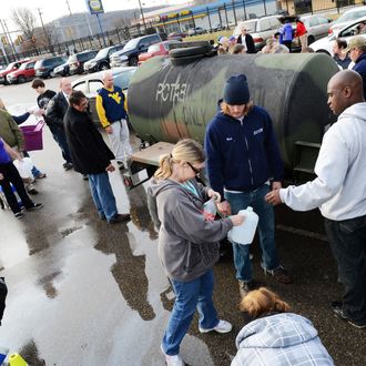West Virginia American Water customers line up for water at the Gestamp Plant after waiting hours for a water truck, only to have it empited in about 20 minutes on January 10, 2014 in South Charleston, West Virginia.