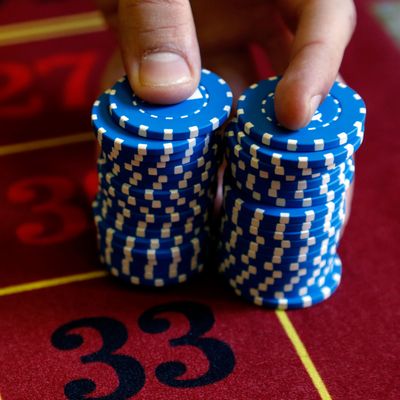 A young croupier trainee displays chips on a gaming table at the Cerus Casino Academy in Marseille
