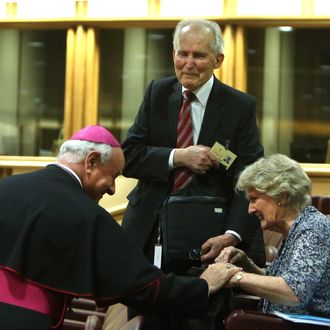 VATICAN CITY, VATICAN - OCTOBER 06: Bishop Msgr Vincenzo Paglia (L) greets a couple before the first sessions of the Synod on the themes of family at the Synod Hall on October 6, 2014 in Vatican City, Vatican. Pope Francis addressed the Fathers of the Extraordinary Assembly of the Synod of Bishops on Monday, as they began their first full day of sessions exploring the pastoral challenges of the family in the context of evangelization. (Photo by Franco Origlia/Getty Images)