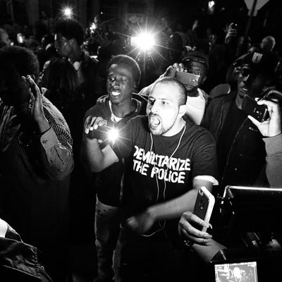 Bassem Masri, center, confronting a St. Louis police officer in Ferguson, Missouri on Wednesday, Oct. 8, 2014.