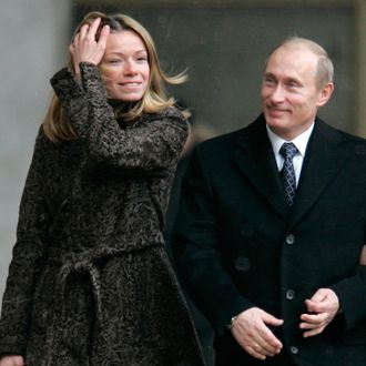 Russian President Vladimir Putin, center, and his wife Lyudmila, right, walk to a polling station in Moscow, Russia, Sunday, Dec. 2, 2007. Russians voted Sunday in a parliamentary election where the only question is whether President Vladimir Putin's party will win merely a strong majority of seats or a crushing share. A woman at left is unidentified. (AP Photo/Ivan Sekretarev)