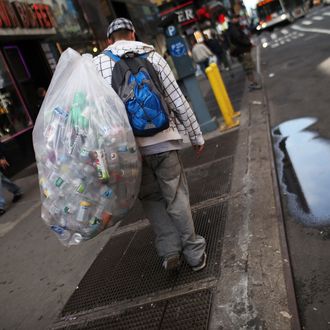 A teenager who collects bottles and cans and lives in a city shelter walks near Times Square on April 14, 2011 in New York City. 