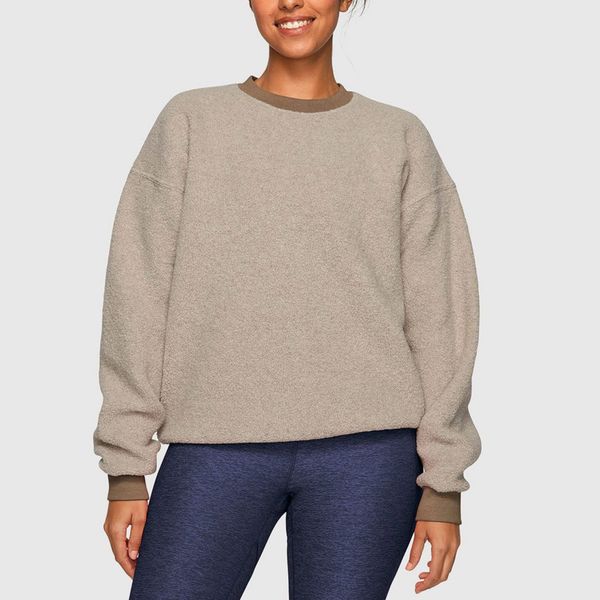 A soft Outdoor Voices MegaFleece Crewneck in a light grey-brown with brown cuffs and crewneck trim worn with dark wash jeans. The Strategist - 48 Things on Sale You’ll Actually Want to Buy: From Sunday Riley to Patagonia 