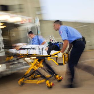 Paramedics loading patient into ambulance