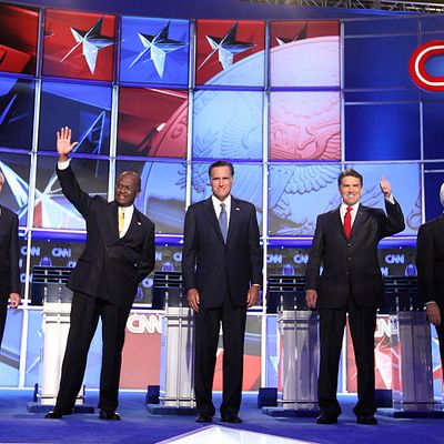 (L-R) U.S. Sen. Rick Santorum (R-PA), U.S. Rep. Ron Paul (R-TX), former CEO of Godfather's Pizza Herman Cain, former Massachusetts Gov. Mitt Romney, Texas Gov. Rick Perry, Former Speaker of the House Newt Gingrich and U.S. Rep. Michele Bachmann (R-MN) say the Pledge of Alligence during the Republican Presidential debate hosted by CNN and The Western Republican Leadership Conference on October 18, 2011 at the The Venetian Resort Hotel Casino in Las Vegas, Nevada. AFP PHOTO / John GURZINSKI (Photo credit should read JOHN GURZINSKI/AFP/Getty Images)