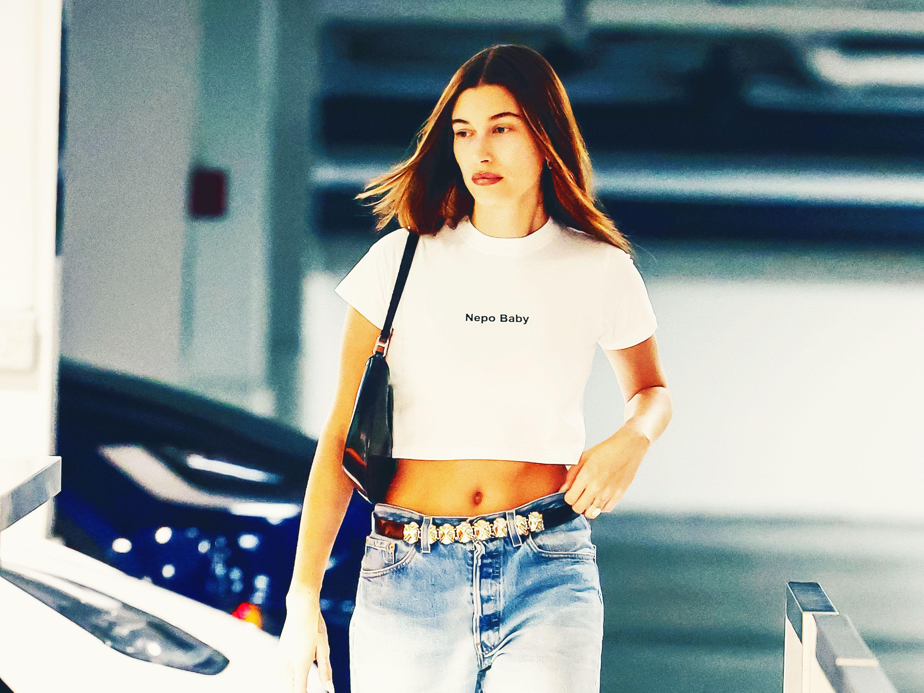 Hailey Baldwin reveals midriff in white shirt with jeans