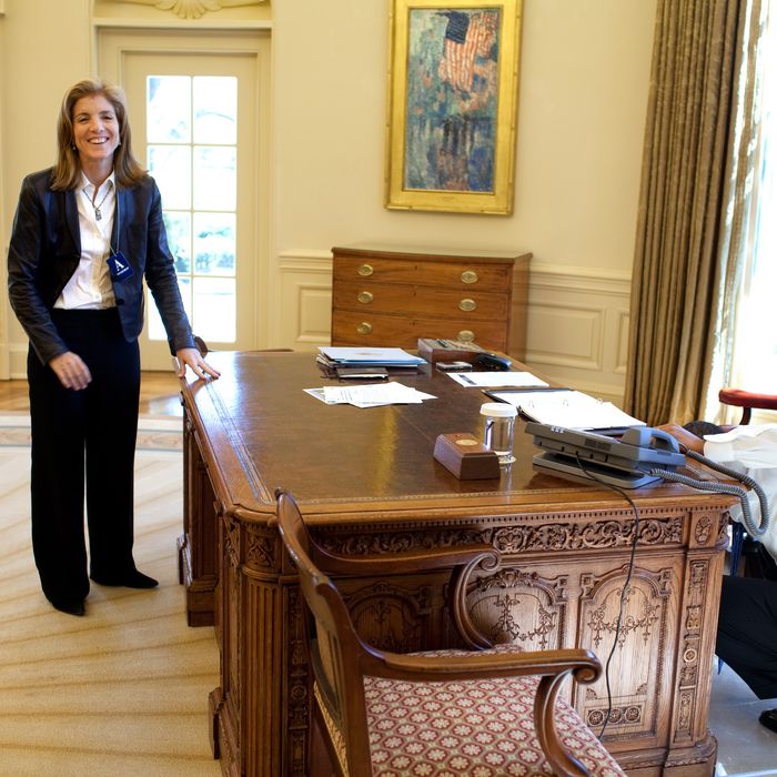 WASHINGTON - MARCH 3: In this handout provide by the White House, U.S. President Barack Obama examines the Resolute Desk while visiting with Caroline Kennedy Schlossberg recalling the famous photograph, her brother John F. Kennedy Jr., peeking through the FDR panel, while his father President Kennedy worked, in the Oval Office of the White House on March 3, 2009 in Washington, DC. Obama is serving as the 44th President of the U.S. and the first African-American to be elected to the office of President in the history of the United States. (Photo by Pete Souza/White House via Getty Images)