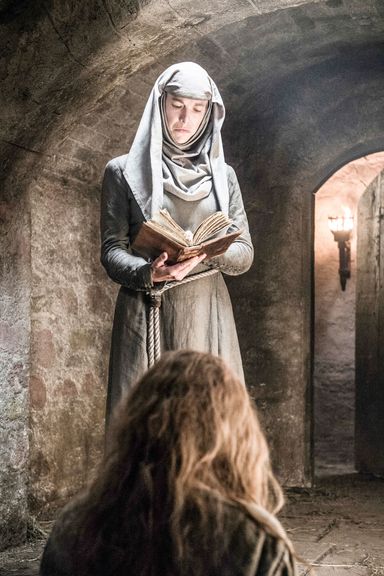 The High Sparrow still rules, for now. The Faith may have lost one queen to a walk of shame, but they have another would-be penitent in her cell, Margaery Tyrell (or is it Margaery Lannister by now?). As punishment for her crimes, our favorite "Shame" Septa is taunting her with her prerelease copy of The Winds of Winter — without sharing! No, wait ... it's probably a religious tome, such as The Seven-Pointed Star. Margaery's getting quite the education.