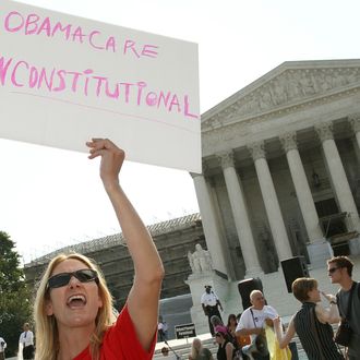 WASHINGTON, DC - JUNE 28: A women protests against the Obama administrations health care plan during a protest in front of the U.S. Supreme Court, on June 28, 2012 in Washington, DC. Today the high court is expected to rule on the constitutionality of the sweeping health care law championed by President Barack Obama. (Photo by Mark Wilson/Getty Images)