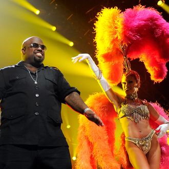 LAS VEGAS, NV - FEBRUARY 18: (EXCLUSIVE COVERAGE) Recording artist Cee Lo Green (L) performs with a showgirl from the Jubilee! production show at the Keep Memory Alive foundation's 