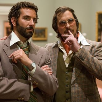 Richie Dimaso (Bradley Cooper, left) and Irving Rosenfeld (Christian Bale) talk in a gallery at the Frick Museum in Columbia Pictures' AMERICAN HUSTLE.