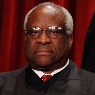 U.S. Supreme Court Associate Justice Clarence Thomas poses for photographs in the East Conference Room at the Supreme Court building October 8, 2010 in Washington, DC. This is the first time in history that three women are simultaneously serving on the court. 