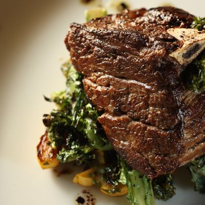 Forty-day-dry-aged bone-in filet with delicata-squash salsa verde and grilled winter greens.