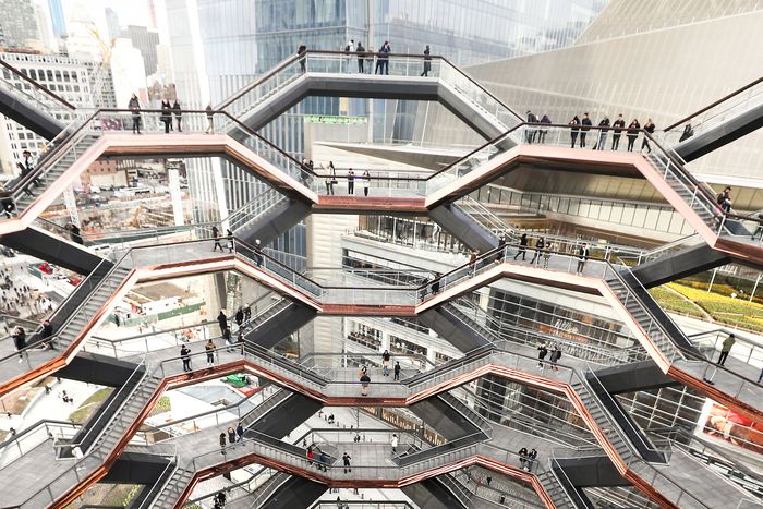 Visitors standing on viewing platforms at the Vessel, a public art structure at Hudson Yards.