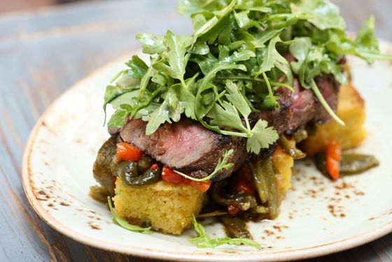 Steak bavette with cornbread panzanella and roasted and pickled poblanos.