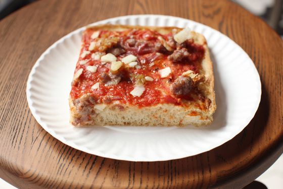 Grandma pizza with crushed tomato, pecorino, sausage, caramelized onion, and garlic butter (from the Slice Shop).