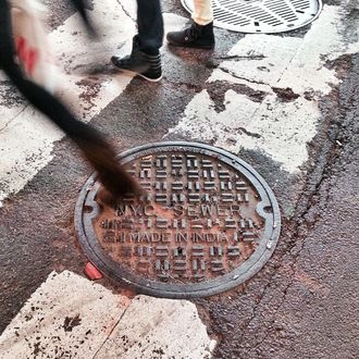 USA, New York City, Manhattan, Times Square, People stepping on manhole cover