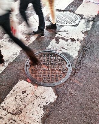USA, New York City, Manhattan, Times Square, People stepping on manhole cover