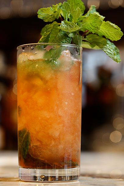 This is the Spritzle, made with Flor De Cana 7-Year-Old Rum, Aperol, Rumple Minze, demerara sugar, and mint.