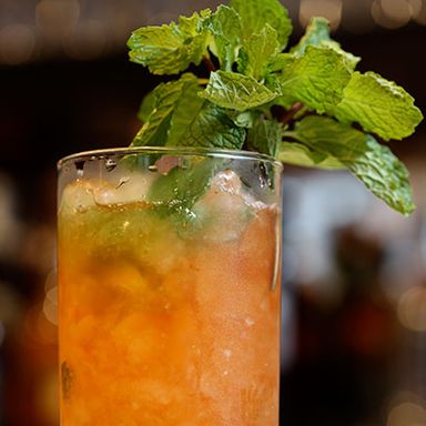 This is the Spritzle, made with Flor De Cana 7-Year-Old Rum, Aperol, Rumple Minze, demerara sugar, and mint.